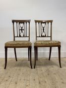 A pair of Edwardian satinwood inlaid mahogany side chairs with upholstered seats, raised on square