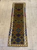 A Maimana kilim runner rug of typical geometric design with running dog border, 295cm x 89cm