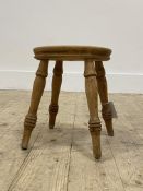 A turned ash stool with four supports. H29cm