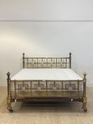 An impressive Aesthetic period 5'6" brass bed, box and tube section head and foot board, moving on