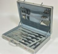 A Bachmayr aluminium case containing a set of stainless steel kitchen knives complete with carving