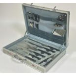 A Bachmayr aluminium case containing a set of stainless steel kitchen knives complete with carving