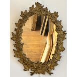 A 19thc cast iron ivy leaf and berry oval wall mirror with gilded decoration (47cm x 35cm)