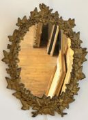 A 19thc cast iron ivy leaf and berry oval wall mirror with gilded decoration (47cm x 35cm)