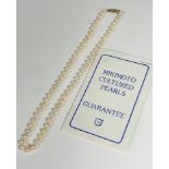 A strand of Mikimoto matched pearls with 9ct gold clasp fastening set three half seed pearls (23cm),