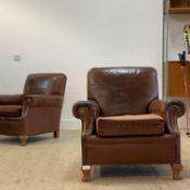 A pair of club armchairs, circa 1930's, upholstered in studded tan leather, with squab cushions,