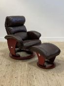 A Danish style reclining easy chair, upholstered in brown leather, raised on a circular swivel