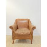 A club armchair, upholstered in tan brown studded leather, raised on square tapered and splayed