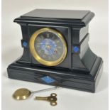 A Victorian black slate mantel clock, the moulded rectangular top above a lapis inlaid circular