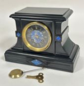 A Victorian black slate mantel clock, the moulded rectangular top above a lapis inlaid circular
