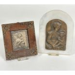 A white arched marble panel containing a Renaissance cast bronzed finish copy of Madonna and