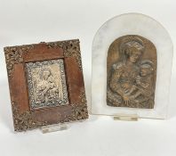 A white arched marble panel containing a Renaissance cast bronzed finish copy of Madonna and