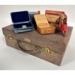 A stamped embossed leather vanity case with cream lined interior by Finnegan's London with