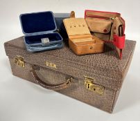 A stamped embossed leather vanity case with cream lined interior by Finnegan's London with