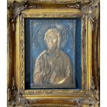 A relief cast icon style panel highlighted with gold in gilt glazed composition moulded frame (