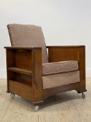An Art Deco period walnut reclining library chair with ash tray and book trough to each end,