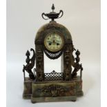 An Egyptian revival onyx mantel clock, late 19th century, the case with urn final over swag,