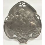 A brass bronzed metal leaf shaped pierced Art Nouveau style dish, two profiles of young ladies