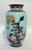 A large Meiji period Japanese cloisonne vase depicting birds and butterflies on a pale blue ground