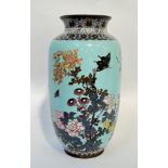 A large Meiji period Japanese cloisonne vase depicting birds and butterflies on a pale blue ground