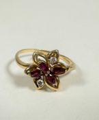 An 18ct gold marquise cut ruby (0.15ct) and two stone diamond floral cluster ring, in open