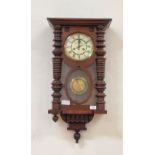 A late Victorian walnut cased Vienna style wall clock by Gustav Becker, the ivorine dial with