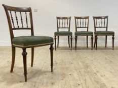A set of four 19th century Aesthetic period walnut dining chairs, incised crest rail over spindle