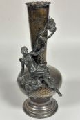 An Epns hammered bottle neck style vase mounted with a winged fairy and cherub, raised on circular