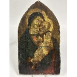 A reproduction varnished paper icon mounted on antique pine arched panel depicting Mary and Jesus