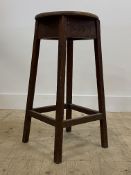 An early 20th century oak stool with circular seat and square tapered supports. H70cm