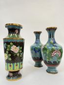 A pair of Chinese cloisonne vases decorated with flowers against a blue ground with cloud motifs,