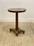 A William IV rosewood pedestal table with cirular top, tapered column and quatrefoil base with bun
