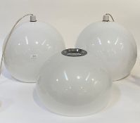 A pair of Vintage pendent light fittings, each with white translucent moulded polyurethane spherical