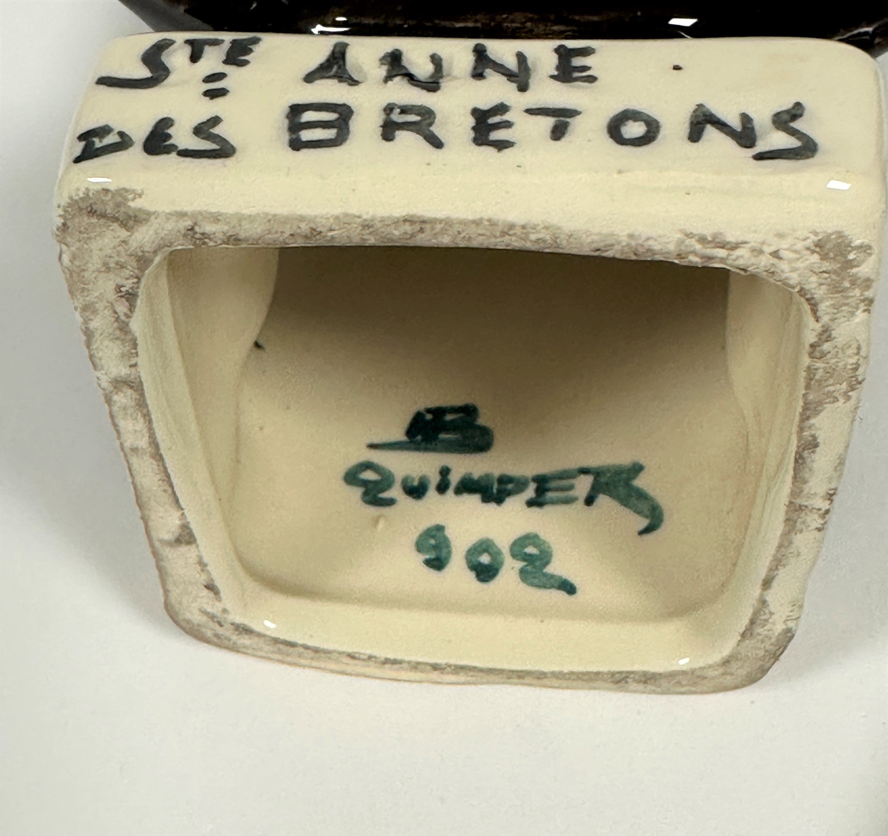 A pottery moulded Quimper figure, Ste. Anne des Bretons, complete with Child and Anchor, signed - Image 2 of 2