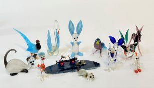 A group of various miniature glass animals such as a cat, deer, donkey, rabbit, swan, duck and two