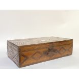 A late 19th century carved and stained pine carpenters tool box, hinged lid opening to a plain