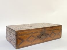 A late 19th century carved and stained pine carpenters tool box, hinged lid opening to a plain