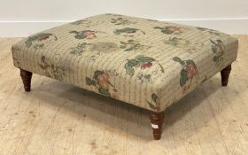 A large upholstered footstool, raised on turned and stained ash supports. H35cm, 103cm x 87cm (