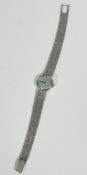 A lady's 9ct white gold wristwatch with circular dial with baton hour markers, on flexible