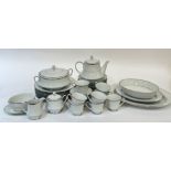 A Noritake Spectrum part dinner service with silver rims comprising two platters, a serving bowl,