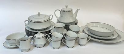 A Noritake Spectrum part dinner service with silver rims comprising two platters, a serving bowl,