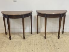 A pair of Edwardian parcel gilt mahogany demi-lune side tables in the Neoclassical taste, the square