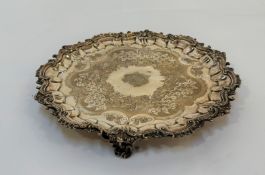 A 19th century silver-plated salver, circular, with shell and scroll-cast rim, engraved to the