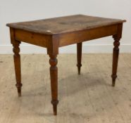 A Victorian pine kitchen table, with rectangular top raised on turned supports H77cm, W109cm, D69cm
