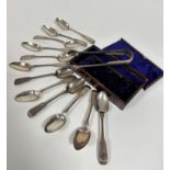 A set of twelve George IV Edinburgh silver fiddle pattern teaspoons with engraved initials GMK,