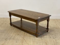 Ercol, a stained elm coffee table, the rectangular top over turned and block supports untied by an