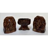 A group of three 19th century treacle-glazed pottery sash window rests: two modelled as lion