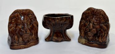 A group of three 19th century treacle-glazed pottery sash window rests: two modelled as lion