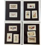 Four glazed frames containing a collection of souvenir and WWI embroidered greeting cards (each