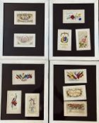 Four glazed frames containing a collection of souvenir and WWI embroidered greeting cards (each